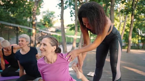 Women doing yoga in urban park
