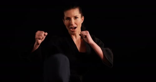 Woman Practicing Martial Arts in a Black Outfit