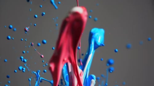 Red And Blue Paint Splashing Together In Abstract Shapes