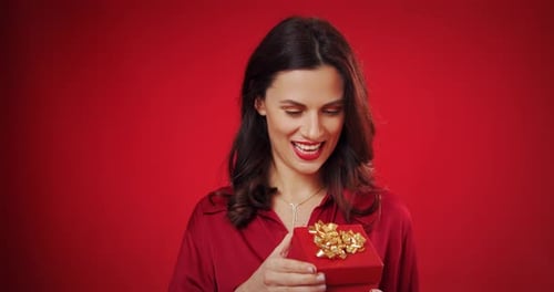 Young Woman Holding a Wrapped Birthday Gift
