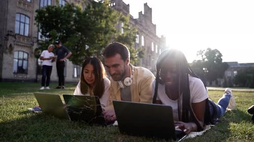 Students Working Together on Laptops on College Campus