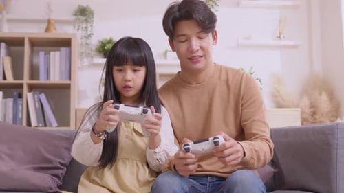 Young Adult and Child Playing Video Games