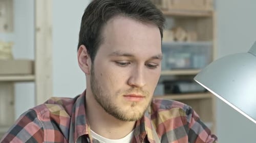 Man working at Desk Indoors in Close Up