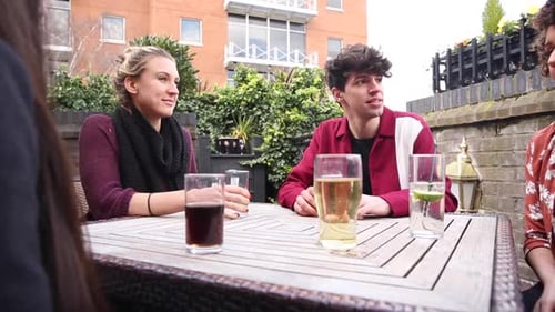 Friends Chatting over Drinks on Urban Patio