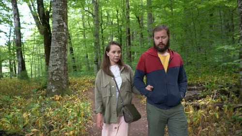 Couple Walking Along a Forest Path