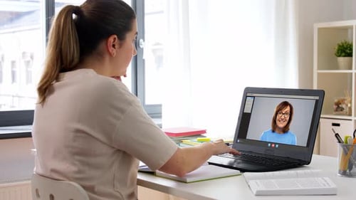 Woman Studies Using Laptop Video Conference at Home