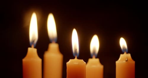 Burning Candles Glowing in the Dark