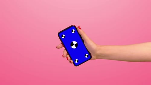 the Girl Enters the Hand with the Phone with a Blue Screen on the Green Background of the Chromakey