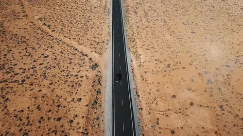 Aerial View of Car Driving Along Highway in the Middle of American Desert with Beautiful Natural