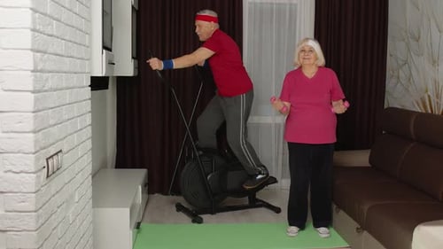 Active Senior Couple Exercising in Living Room