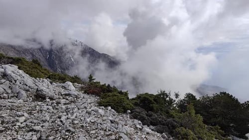 Beautiful clouds passing over a mountain area.