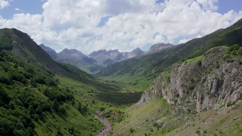 River flowing through valley in mountains