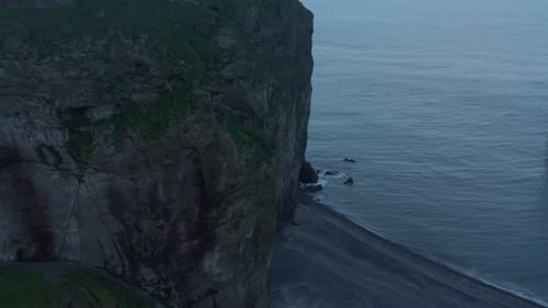 Fly Around Massive Rock at Sea Coast
