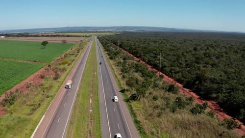 Highway runing through rural Brazil with sparse traffic - aerial view