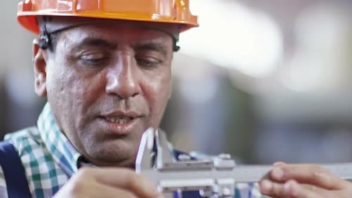 Professional Engineer Measuring Detail with Caliper