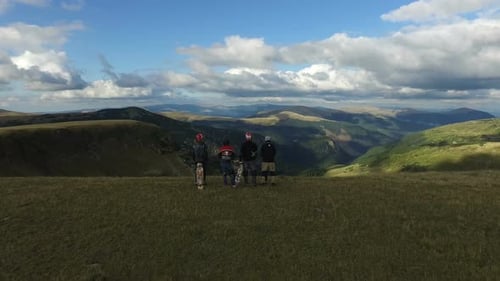 Aerial view of four longboarders standing