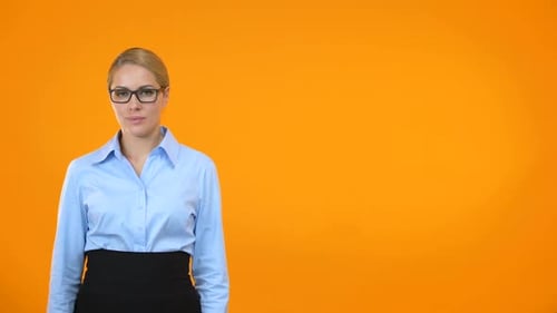 Businesswoman Giving Thumbs Up on Orange Background