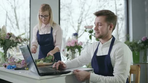 Florist Female and Male Workers Floral Shop Take Orders From in Online Store From Customers for