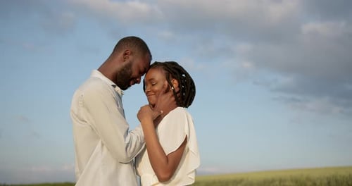 Happy Romantic Couple Hugging in a Summer Field