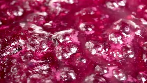 Bubbling Red Fruit Jam in Pot Close Up