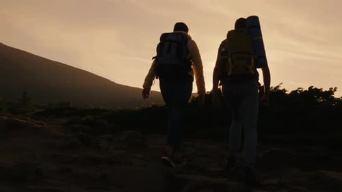 Couple Hiking up Rocky Mountain at Sunrise
