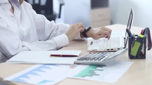 Young Girl Working In A Business Office Using A Modern Laptop