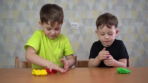 Two Young Boys Playing with Colorful Clay