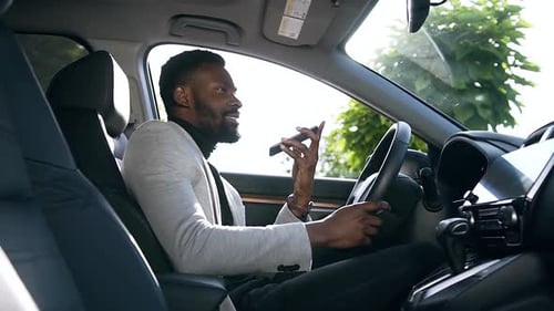 Man Talking on Phone in Car on Sunny Day