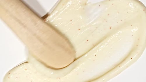 Cosmetic Scrub Being Spread by Wooden Spatula