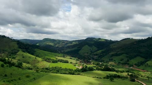 Aerial View of Green Tropical Mountain and Small Valley During Clouded Day