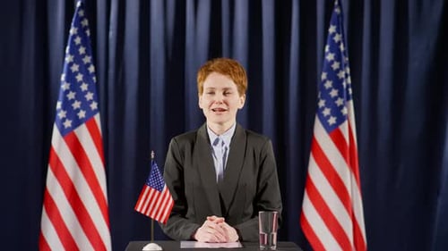 Woman Giving Political Speech with American Flags