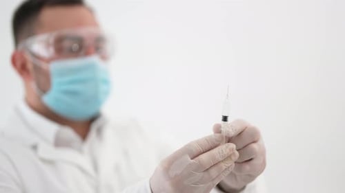 Doctor Preparing Injection in Clean Medical Setting