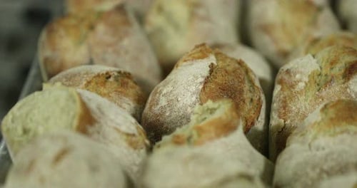 Freshly Baked Sourdough Bread On A Tray In The Bakery. -close up, sliding slow-mo shot
