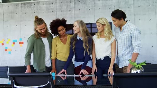 Diverse Team Collaborating on Project in Bright Office