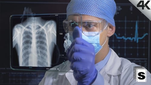 Medical Professional Interacting with Transparent Digital Screen
