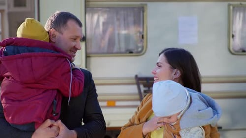 Happy Family Posing with Camper