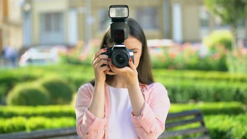 Female Photographer Taking Photos With Camera in Park, Lessons for Beginners