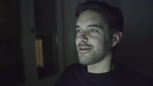 Smiling Young Adult Man Talking At Night
