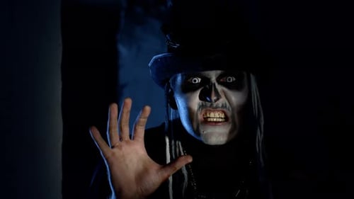 Frightening Man with Halloween Skeleton Makeup Quickly Appears From Dark Corner, Trying To Scare