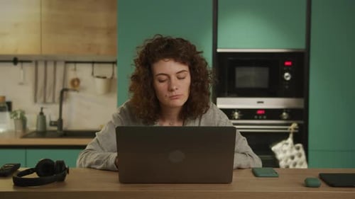 Young 20s Adult Student Reading Upsetting News on Her Laptop