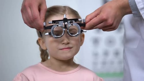 Optometrist Putting Special Glasses on Little Girl, Diagnosing Lazy Eye Illness