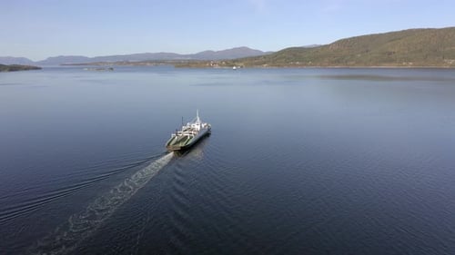 Norwegian Ferry Service Crossing a Fjord Carrying Passengers and Vehicles