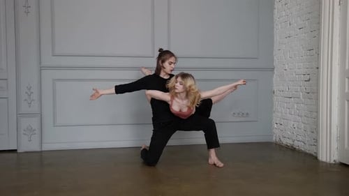 Young Blonde Woman and Talented Man are Dancing Together in Rehearsing Hall Lovers are Dancing