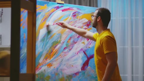 Young Artist Painting Colorful Abstract Art on Canvas