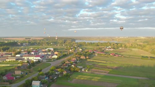 Hot Air Balloons Floating Over Peaceful Countryside