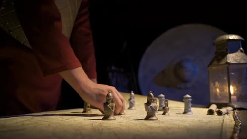 Chess Pieces moved on Map by Candlelight