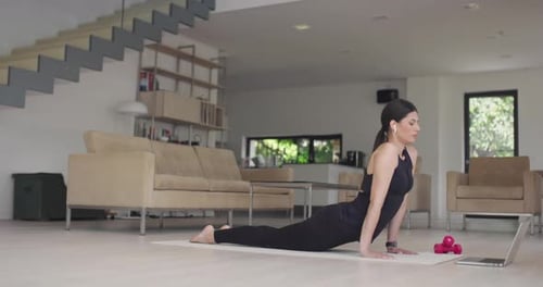 Woman Doing Yoga at Home for Health and Fitness
