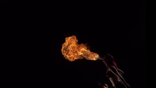 Woman Fire Breathing Performance in Dark Setting