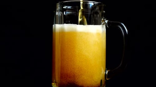 Beer Mug Filled With Dark Beer and Foam