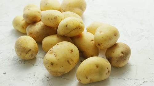Close Up Fresh Potatoes on White Textured Surface